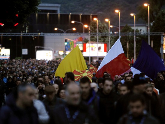 People participate in an anti-government protest, marching through Skopje, Macedonia, Tuesday, May 3, 2016. A few thousand people marched peacefully late Tuesday in Skopje, continuing the protests after the country's president pardoned dozens of politicians who were facing criminal proceedings for alleged involvement in a wiretapping scandal. (AP Photo/Boris Grdanoski)