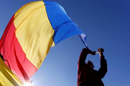 A man waves a Romanian national flag during a march in downtown Bucharest, Romania, October 20, 2013. REUTERS/Bogdan Cristel/File Photo